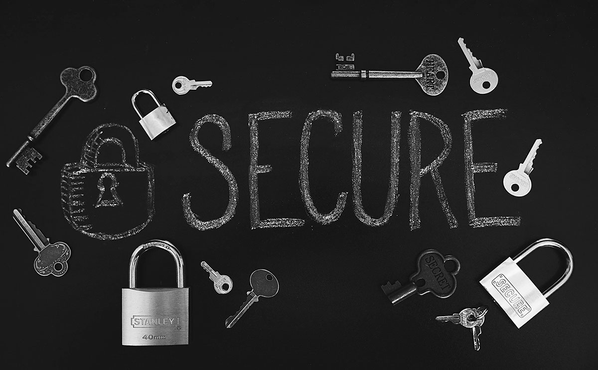 The word secure on a chalkboard with locks and keys